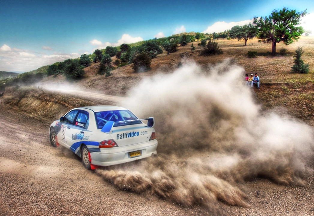 Who pays for the damage done by rally cars during a race?